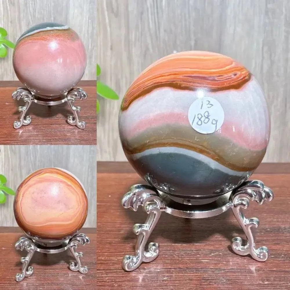 Polychrome Jasper Crystal Sphere: Hand-polished sphere with earthy reds, browns, tans, and grays for grounding and vitality.