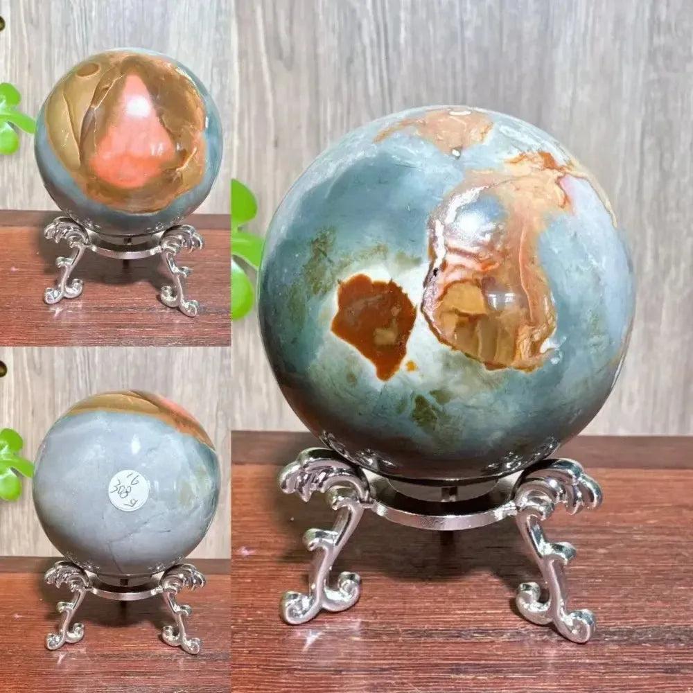 Polychrome Jasper Crystal Sphere: Vibrant earthy reds, browns, tans, and grays swirl on a polished crystal sphere on a silver stand.