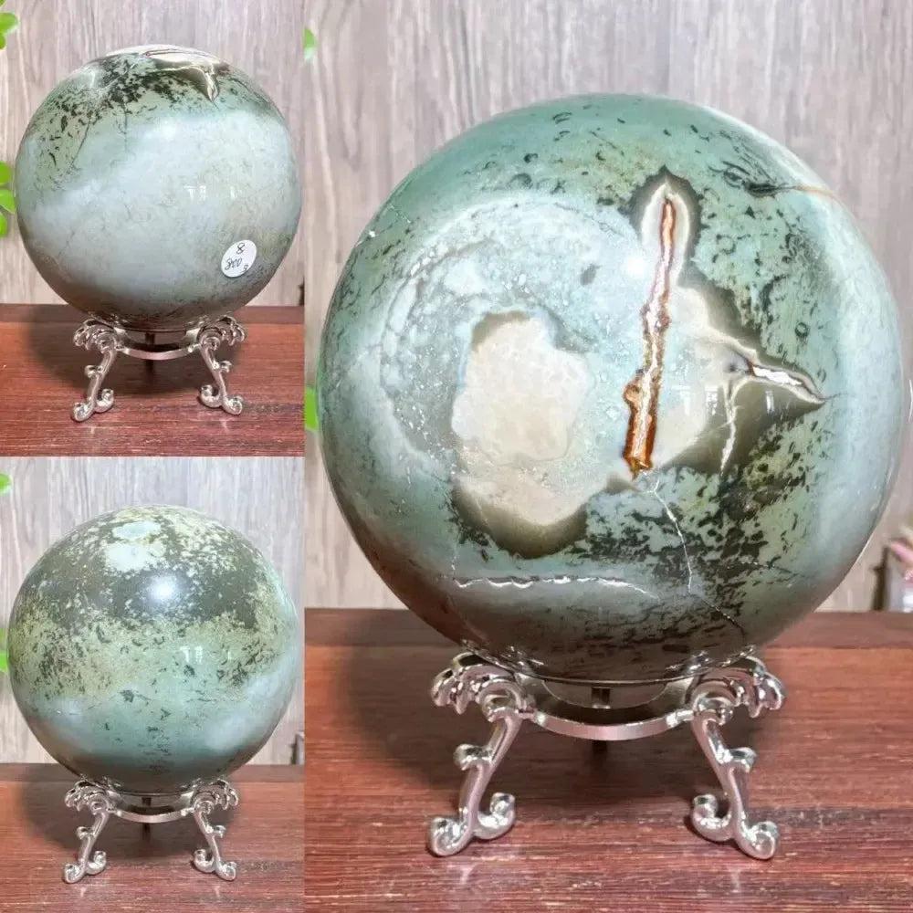 Polychrome Jasper Crystal Sphere: Mesmerizing green, brown, and cream sphere on a silver stand, radiating grounding energy.