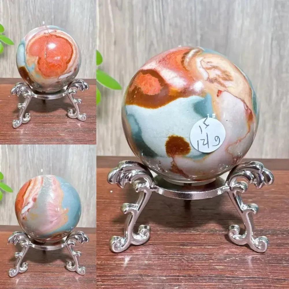 Polychrome Jasper crystal sphere from Crystal Destiny, featuring earthy reds, browns, tans, and grays on a silver stand.