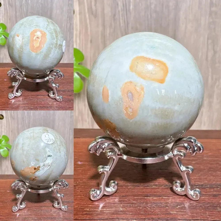 Polychrome Jasper crystal sphere by Crystal Destiny, featuring earthy reds, browns, tans, and grays on a silver stand.