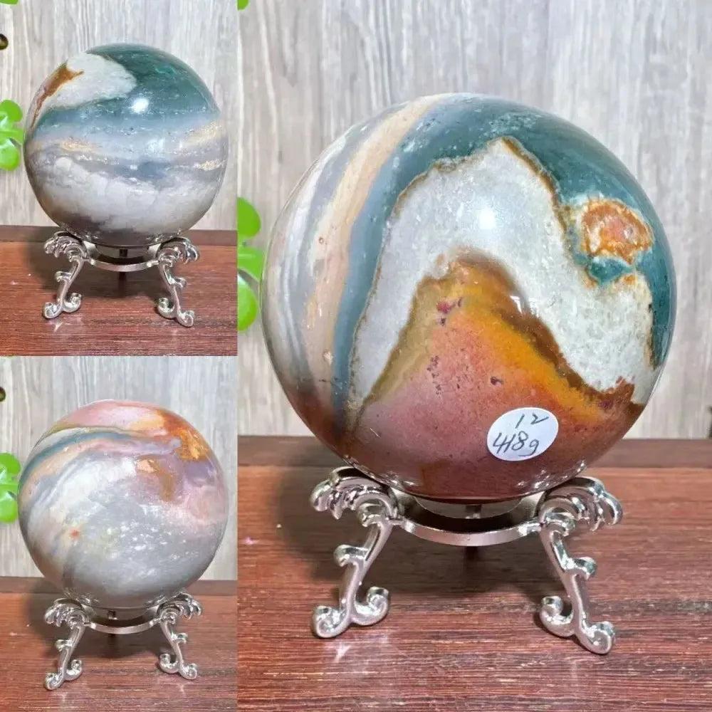 Polychrome Jasper crystal sphere from Crystal Destiny, showcasing earthy reds, browns, tans, grays, and deep greens.