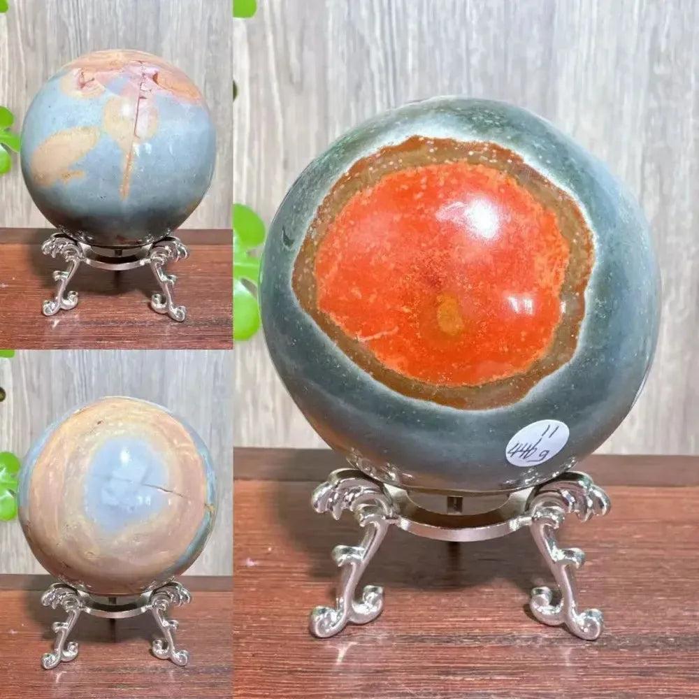 Polychrome Jasper crystal sphere from Crystal Destiny, featuring earthy reds, browns, tans, and grays on a silver stand.