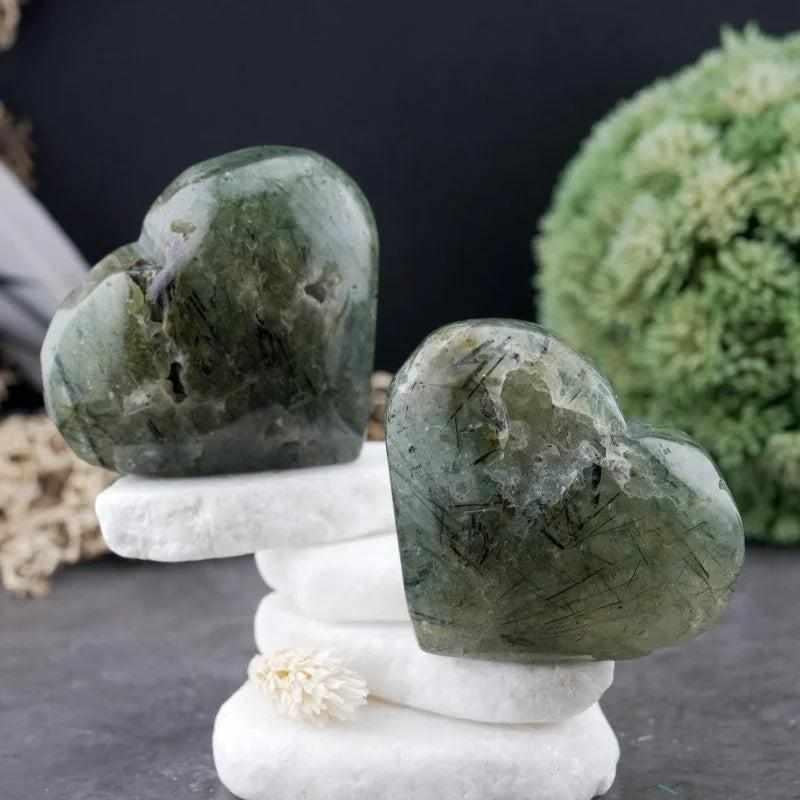 Two polished apple green Prehnite hearts with natural inclusions, perfect for meditation and heart chakra healing.