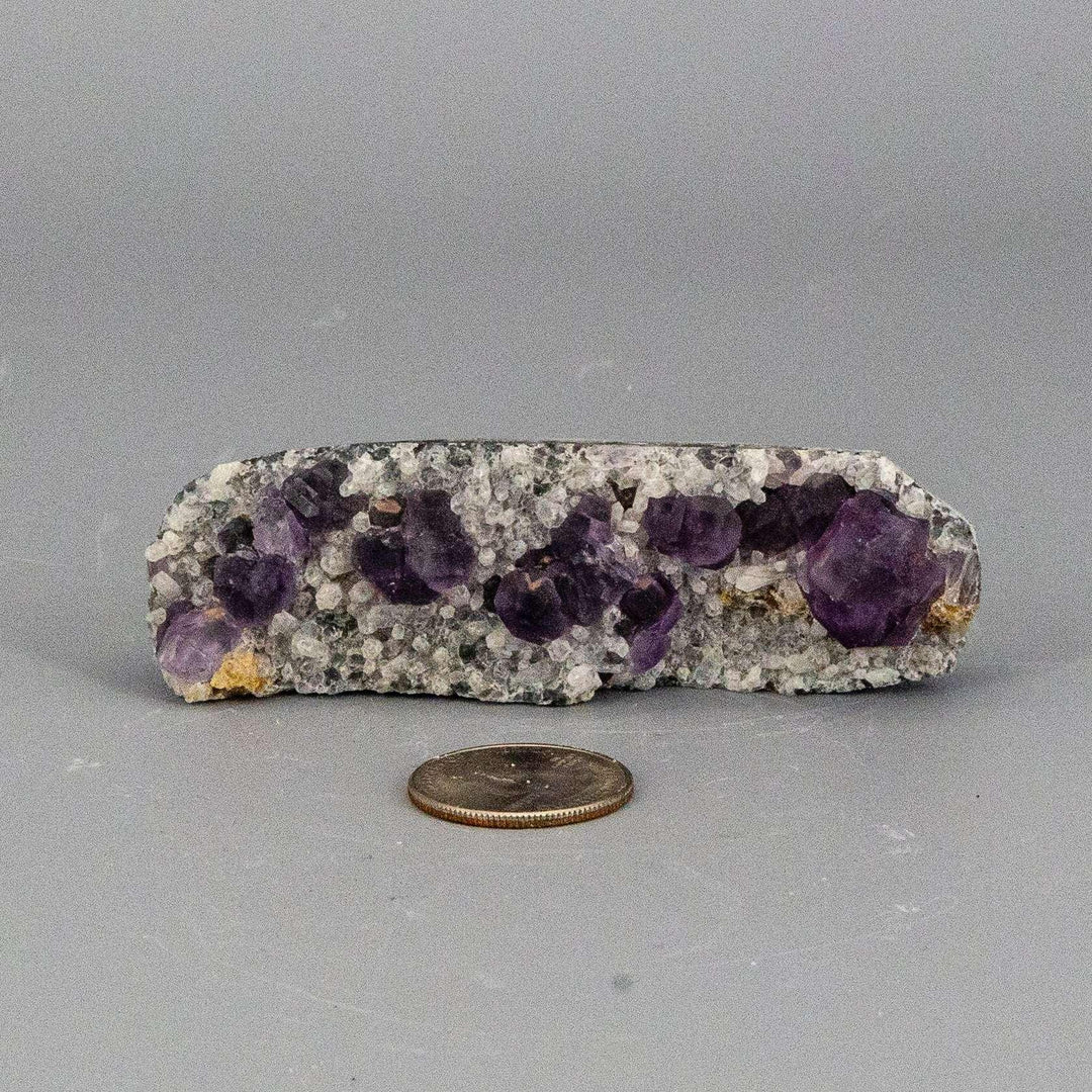 Purple Fluorite Cubes on Calcite "Nubbies" specimen, showcasing deep purple cubes on a creamy, textured base.