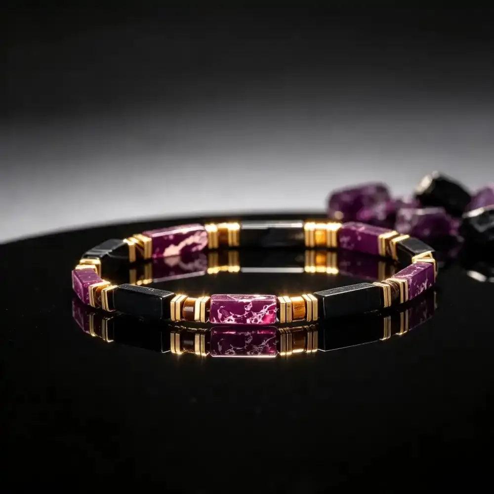 Purple Imperial Jasper and Black Onyx bracelet featuring rectangular beads, gold-tone spacers, and grounding tiger's eye.