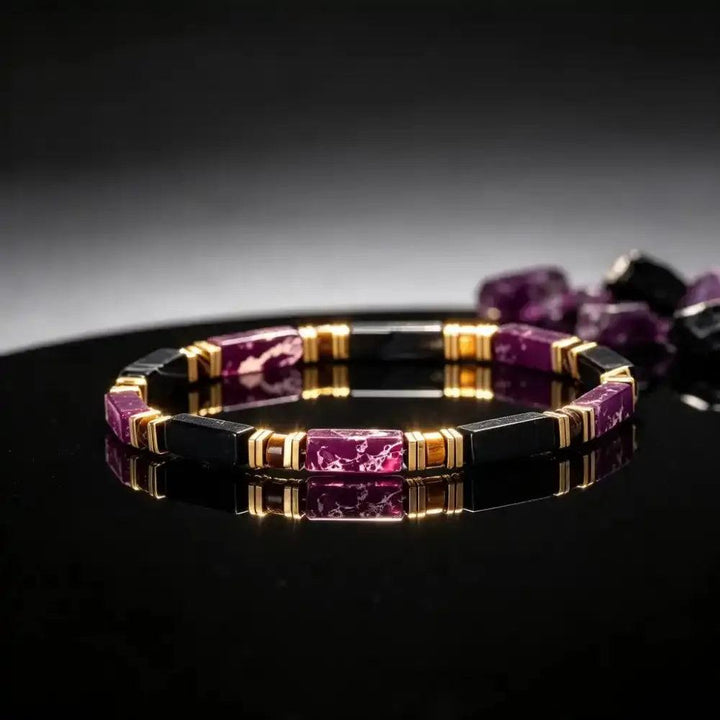 Purple Imperial Jasper and Black Onyx bracelet featuring rectangular beads, gold-tone spacers, and grounding tiger's eye.