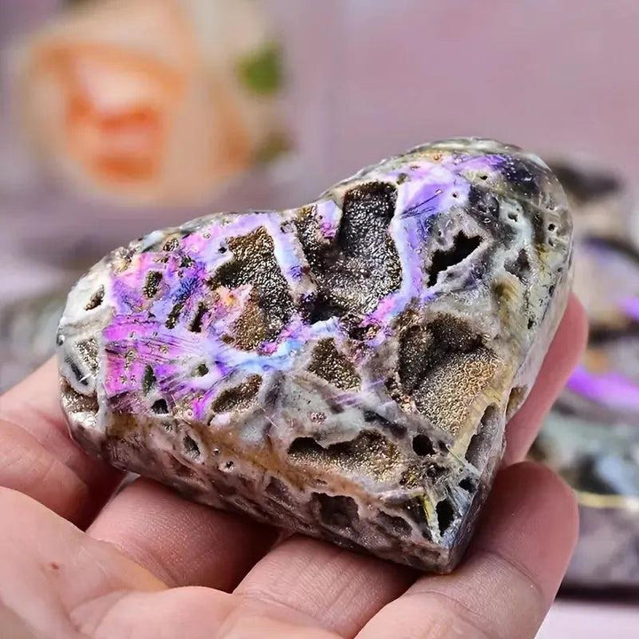 Sparkling Purple Sphalerite druzy heart, iridescent with metallic coating, held in hand by Crystal Destiny.