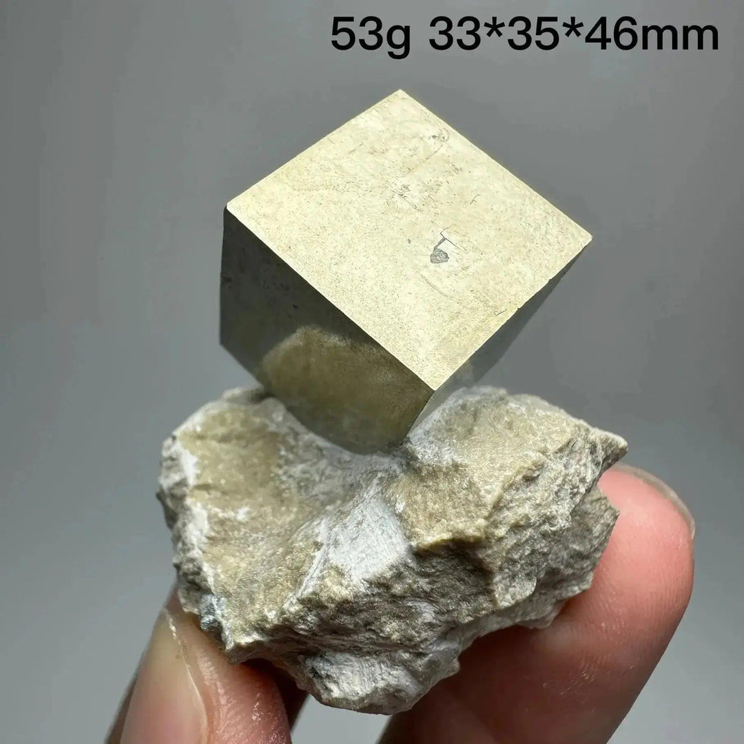 Metallic gold Pyrite Cube Crystal Specimen from Crystal Destiny, naturally formed on a light matrix.