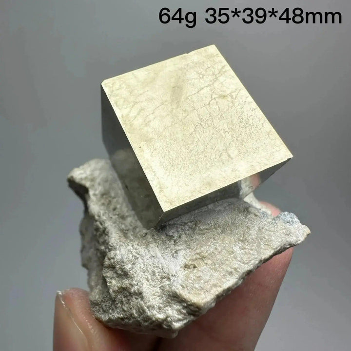 Metallic gold Pyrite Cube Crystal Specimen, naturally formed, resting on a light-colored matrix, from Crystal Destiny.