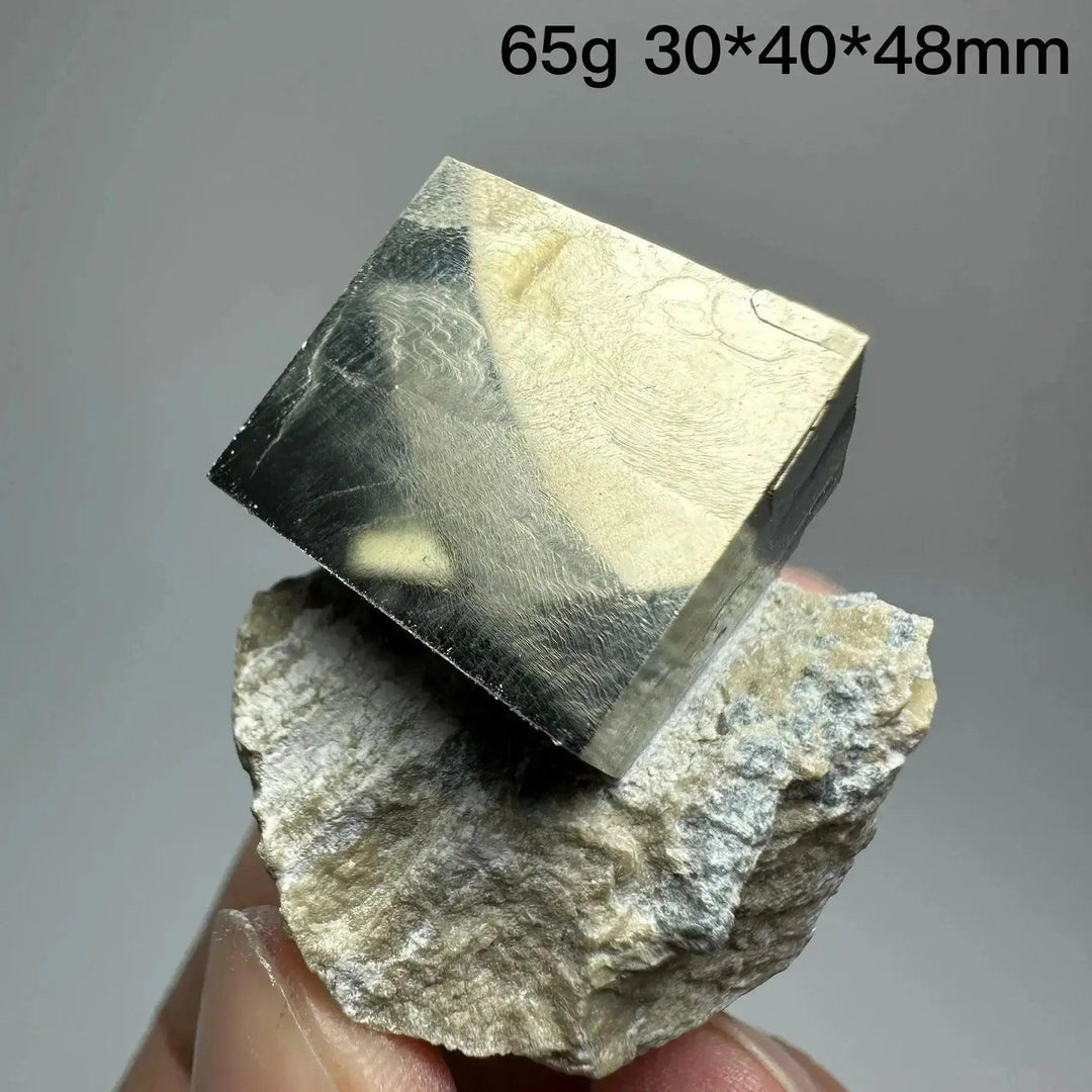 Metallic gold Pyrite Cube Crystal Specimen from Crystal Destiny, naturally formed with sharp edges, on a rough matrix.