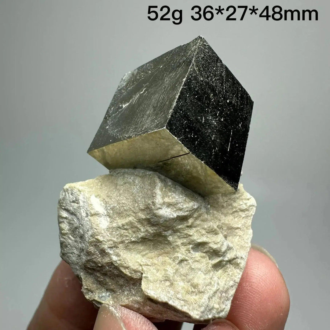 Metallic gold Pyrite Cube Crystal Specimen on a light matrix, showcasing natural geometric perfection from Crystal Destiny.