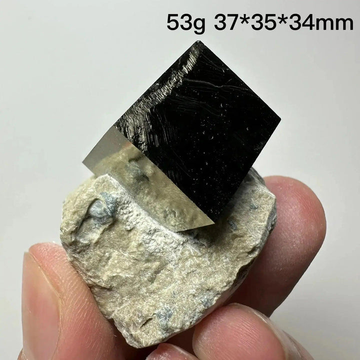 Metallic gold Pyrite Cube Crystal Specimen from Crystal Destiny, naturally formed on a light matrix.