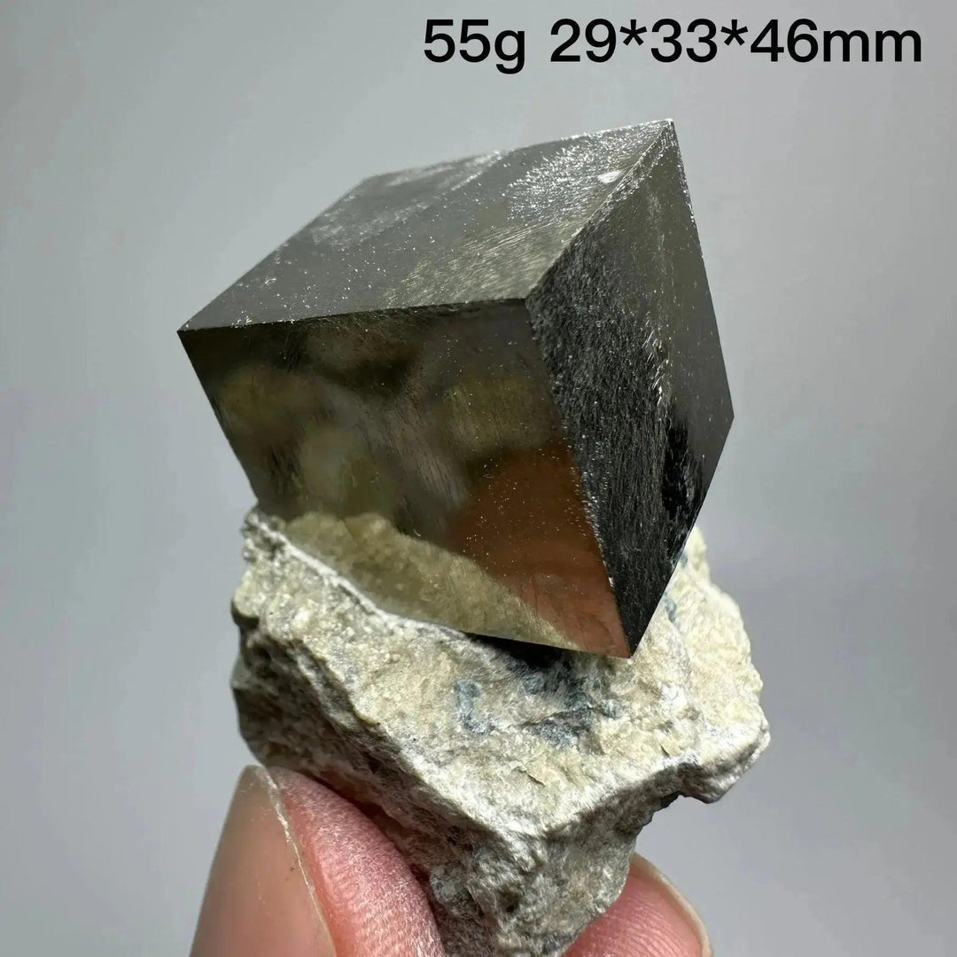Metallic gold Pyrite Cube Crystal Specimen from Crystal Destiny, naturally formed on a light matrix.