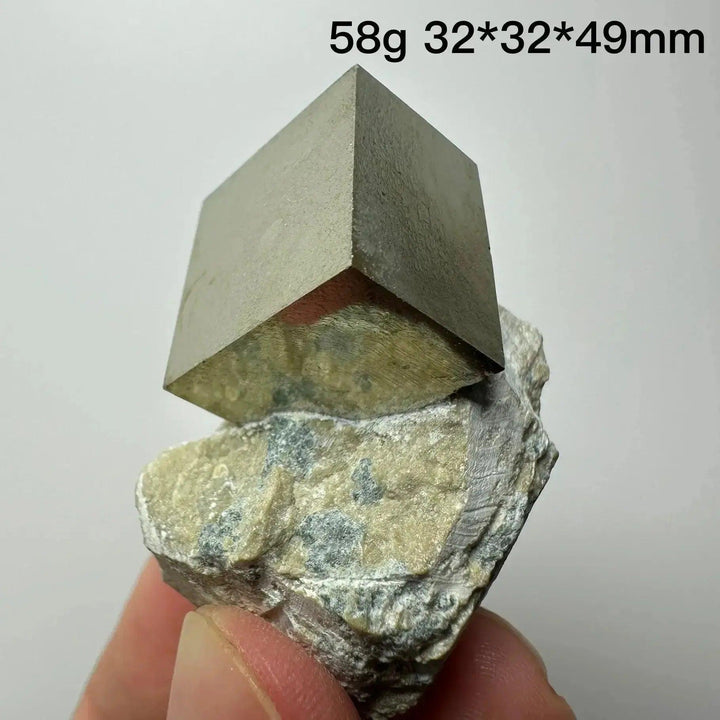 Metallic gold Pyrite Cube Crystal Specimen from Crystal Destiny, naturally formed on a light-colored matrix.