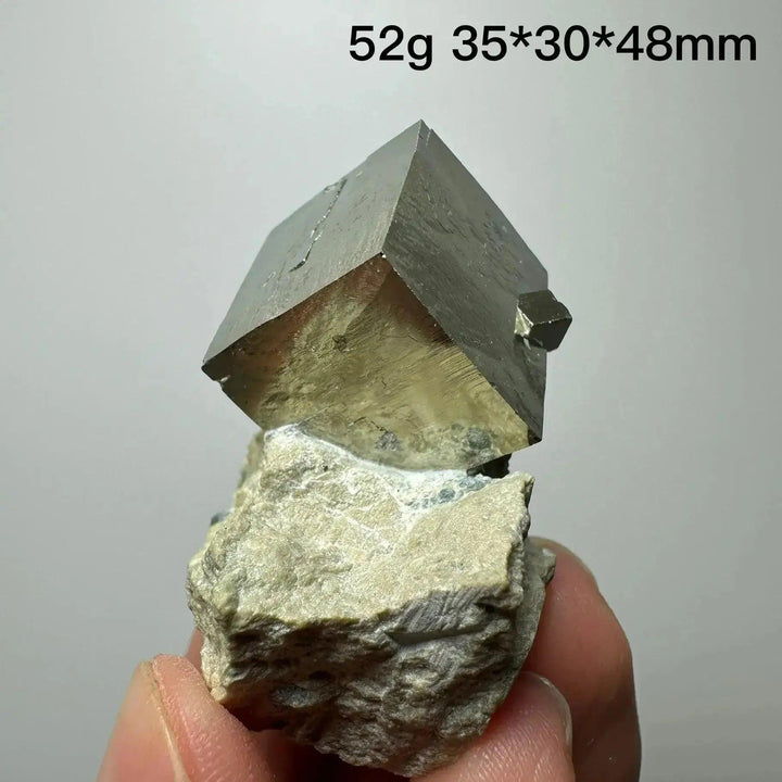 Metallic gold Pyrite Cube Crystal Specimen from Crystal Destiny, naturally formed on a light matrix.