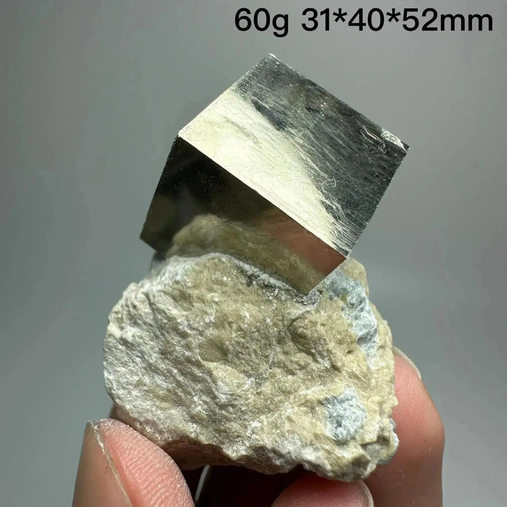 Metallic gold Pyrite Cube Crystal Specimen from Crystal Destiny, naturally formed on a light-colored matrix.