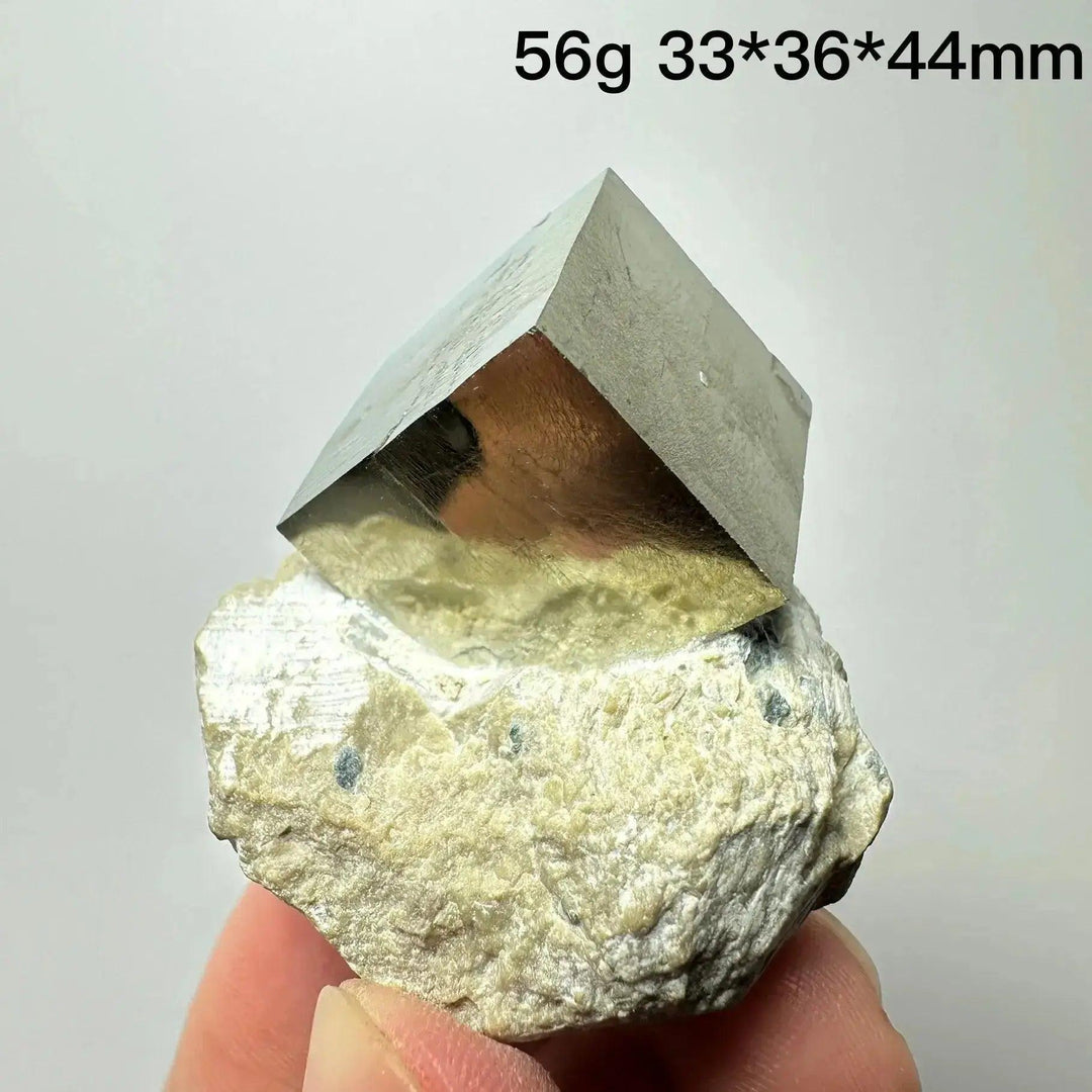 Metallic gold Pyrite Cube Crystal Specimen from Crystal Destiny, naturally formed on a light matrix.