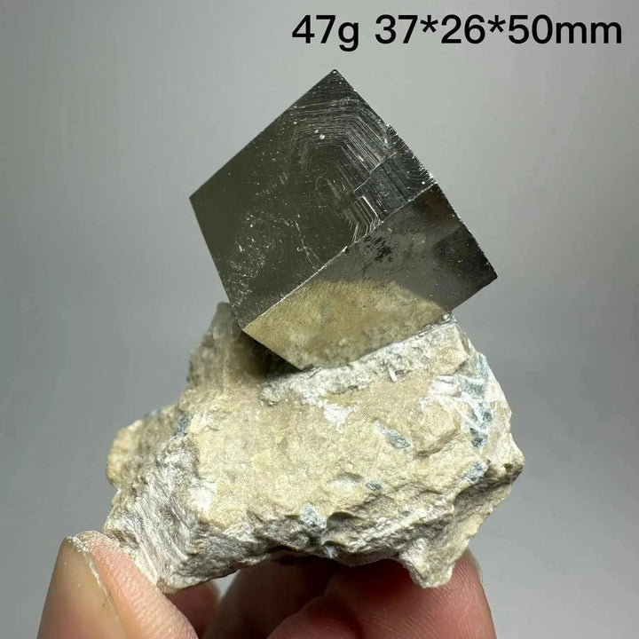 Metallic gold Pyrite Cube Crystal Specimen from Crystal Destiny, naturally formed on a light matrix.
