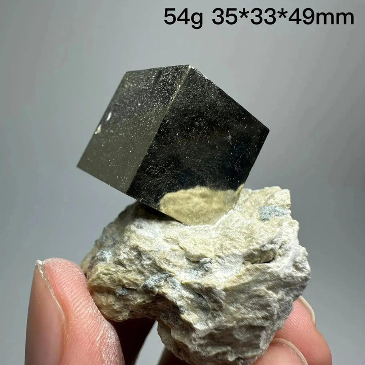 Metallic gold Pyrite Cube Crystal Specimen from Crystal Destiny, naturally formed on a light matrix.