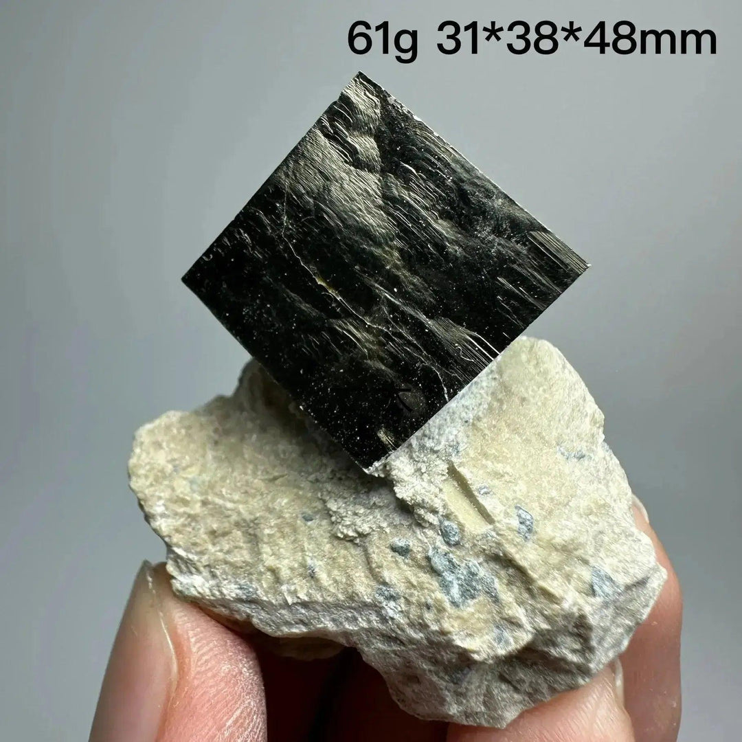 Metallic gold Pyrite Cube Crystal Specimen from Crystal Destiny, naturally formed on a light matrix.