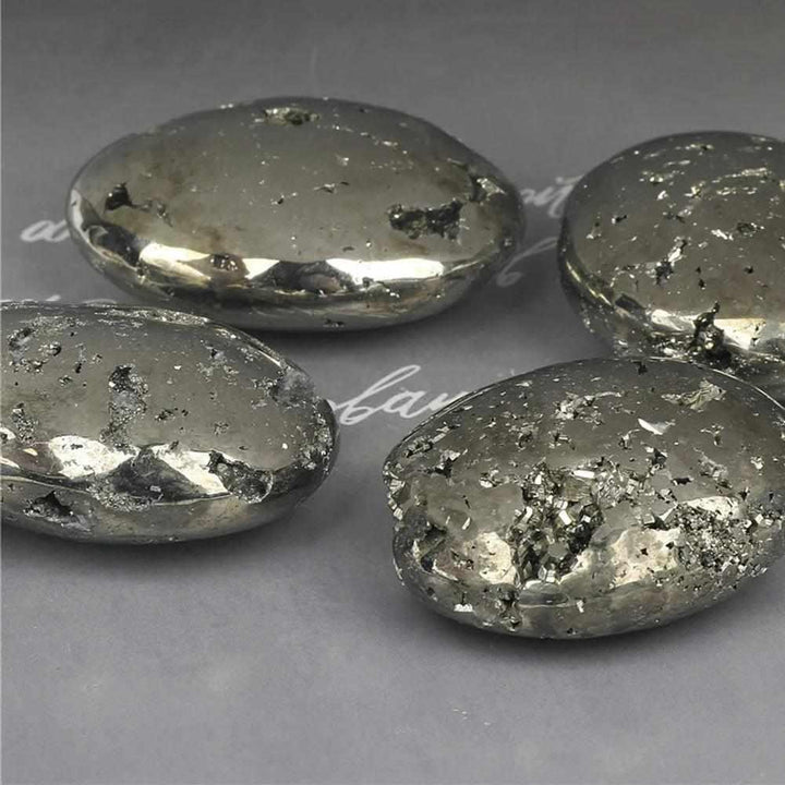 Polished golden Pyrite palm stones with metallic luster, perfect as worry stones for confidence and abundance.