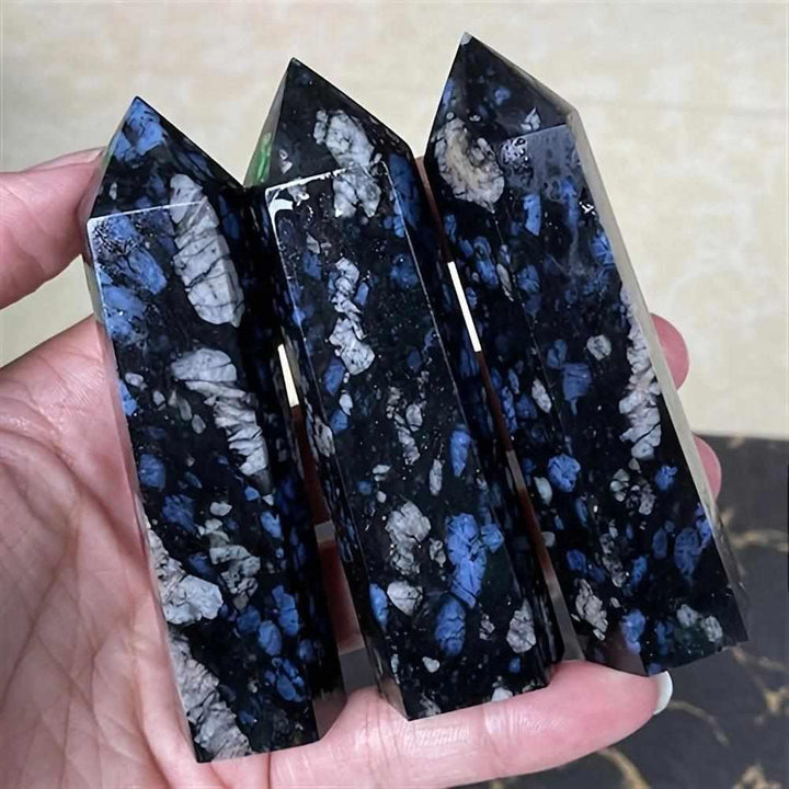 Polished Que Sera stone towers featuring speckled blue, gray, and black patterns for uplifting, universal chakra energy.