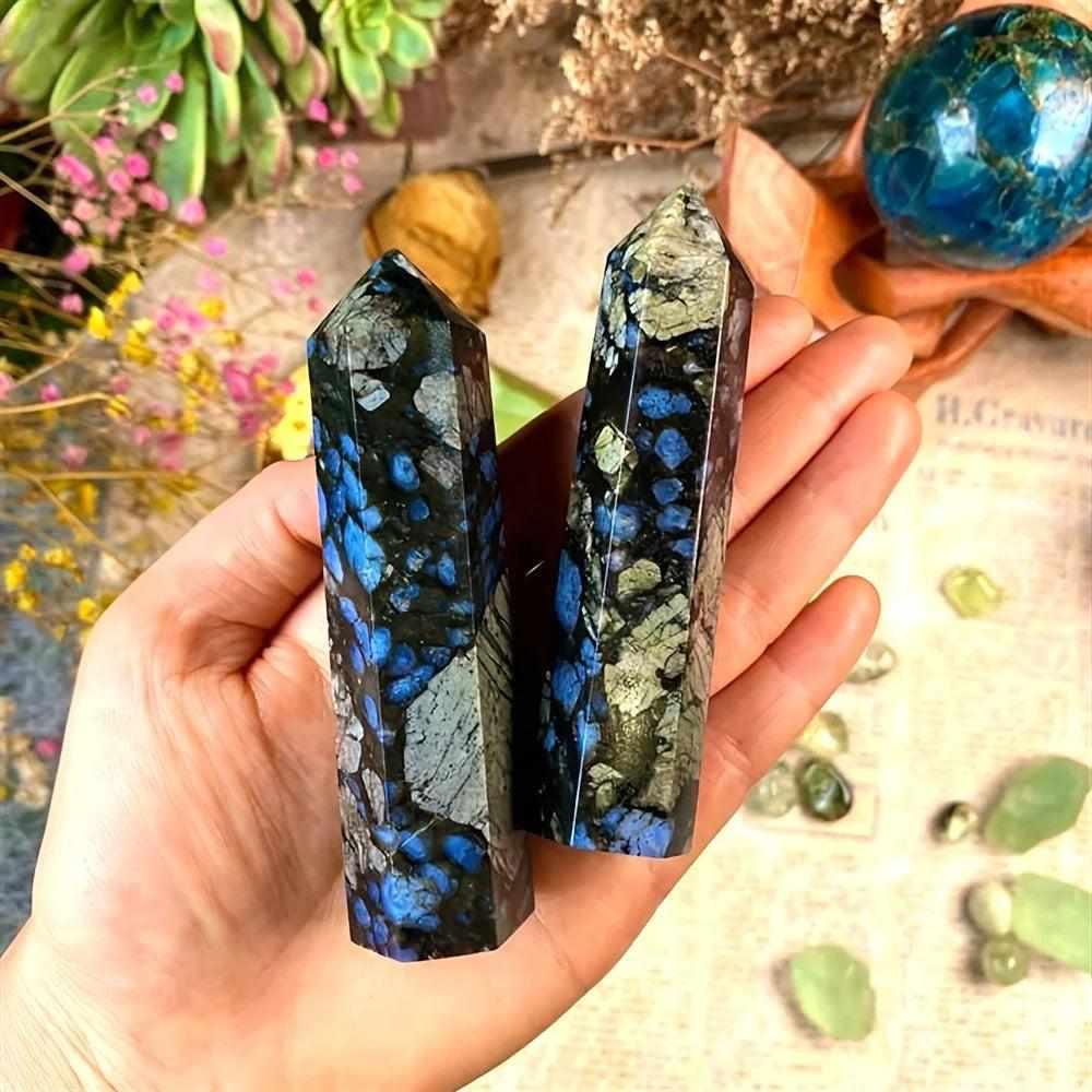 Two polished Que Sera stone towers featuring speckled blue, gray, and brown patterns for uplifting, steady energy.