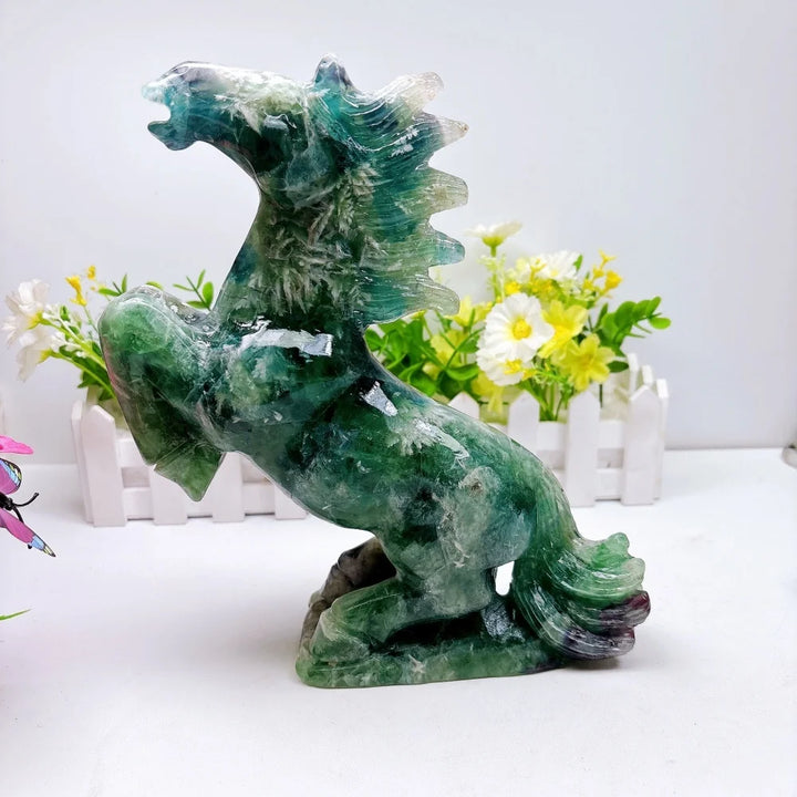 Hand-carved 2.24kg rainbow fluorite horse sculpture featuring vibrant green and purple banding for chakra healing.