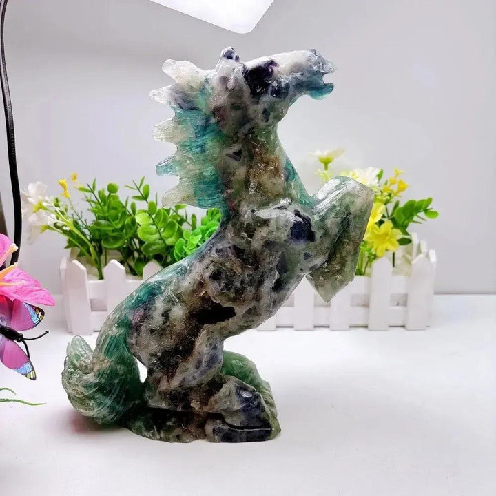 Hand-carved 2.24kg rainbow fluorite horse sculpture featuring vibrant green and purple banding for chakra healing.