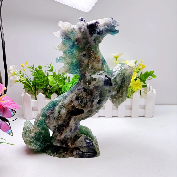 Hand-carved 2.24kg rainbow fluorite horse sculpture featuring vibrant green and purple banding for chakra healing.