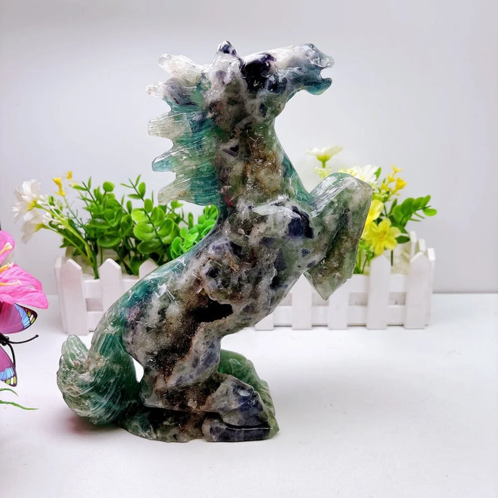 Hand-carved 2.24kg rainbow fluorite horse sculpture featuring vibrant green and purple banding for chakra healing.