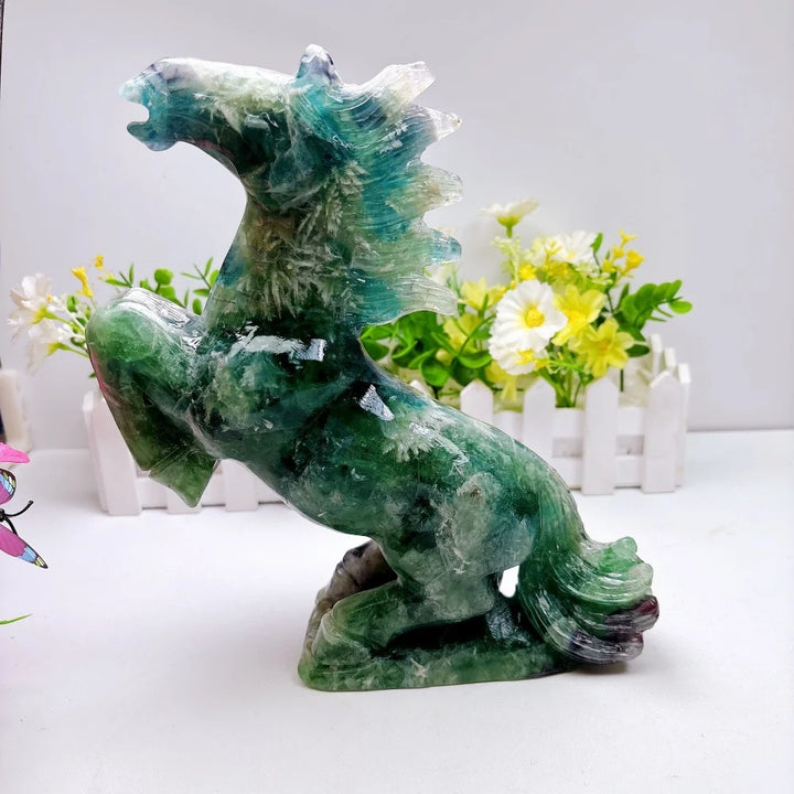 Hand-carved 2.24kg rainbow fluorite horse sculpture featuring vibrant green and purple banding for chakra healing.