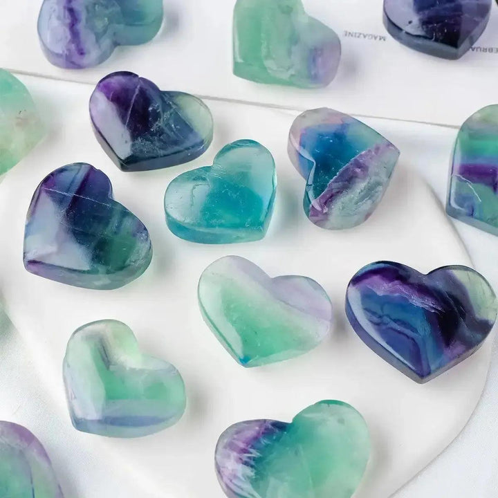 Polished Rainbow Fluorite crystal hearts in purple, green, blue, and clear, from Crystal Destiny.