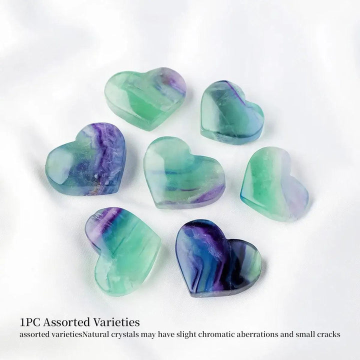 Assorted Rainbow Fluorite crystal hearts from Crystal Destiny, showcasing vibrant purple, green, and blue hues.