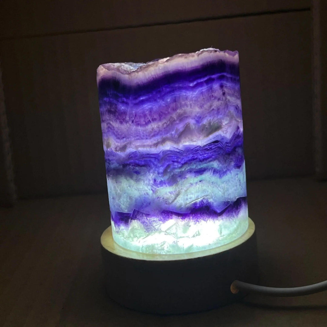 Rainbow Fluorite Crystal Light Lamp with mesmerizing bands of purple, green, and clear, illuminated for clarity and balance.