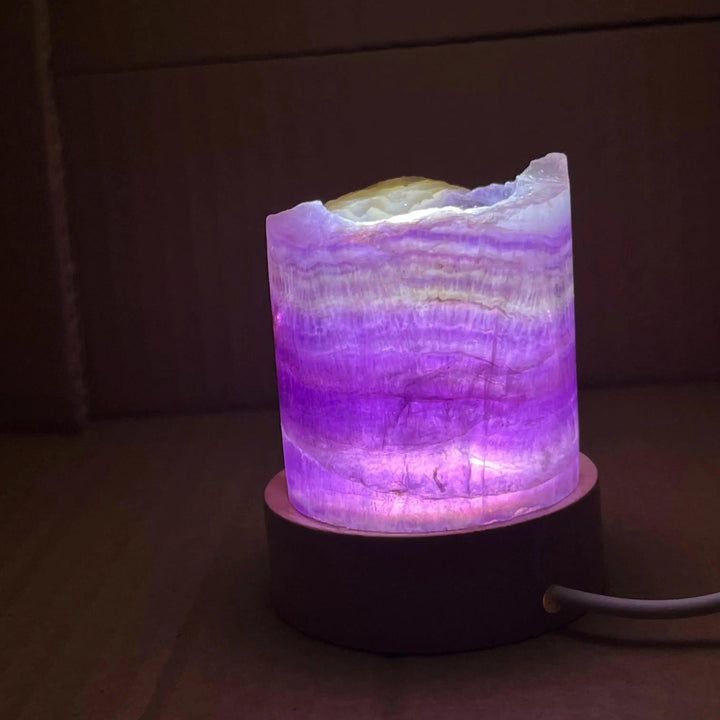 Rainbow Fluorite Crystal Light Lamp with mesmerizing purple, green, and clear bands, illuminated for mental clarity.