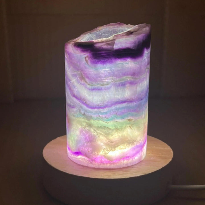 Rainbow Fluorite Crystal Light Lamp with mesmerizing bands of purple, green, blue, and clear, illuminating a soft, ambient glow.