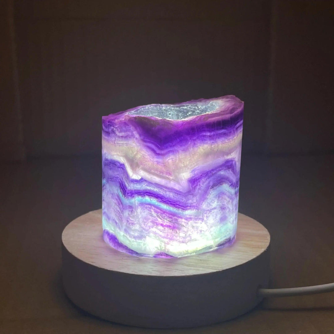 Rainbow Fluorite Crystal Light Lamp: Mesmerizing purple, green, and clear fluorite lamp on a wooden base, glowing with ambient light.