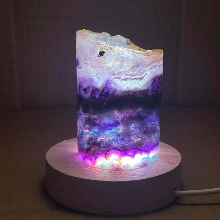 Rainbow Fluorite Crystal Light Lamp: Mesmerizing purple, green, and clear fluorite glows on a light wood base, enhancing clarity.