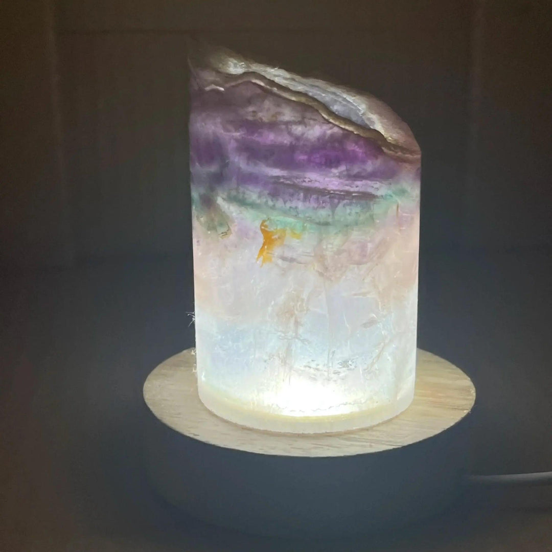 Stunning Rainbow Fluorite Crystal Light Lamp with mesmerizing bands of purple, green, blue, and clear, illuminated from within.