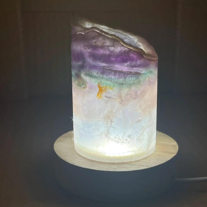 Stunning Rainbow Fluorite Crystal Light Lamp with mesmerizing bands of purple, green, blue, and clear, illuminated from within.