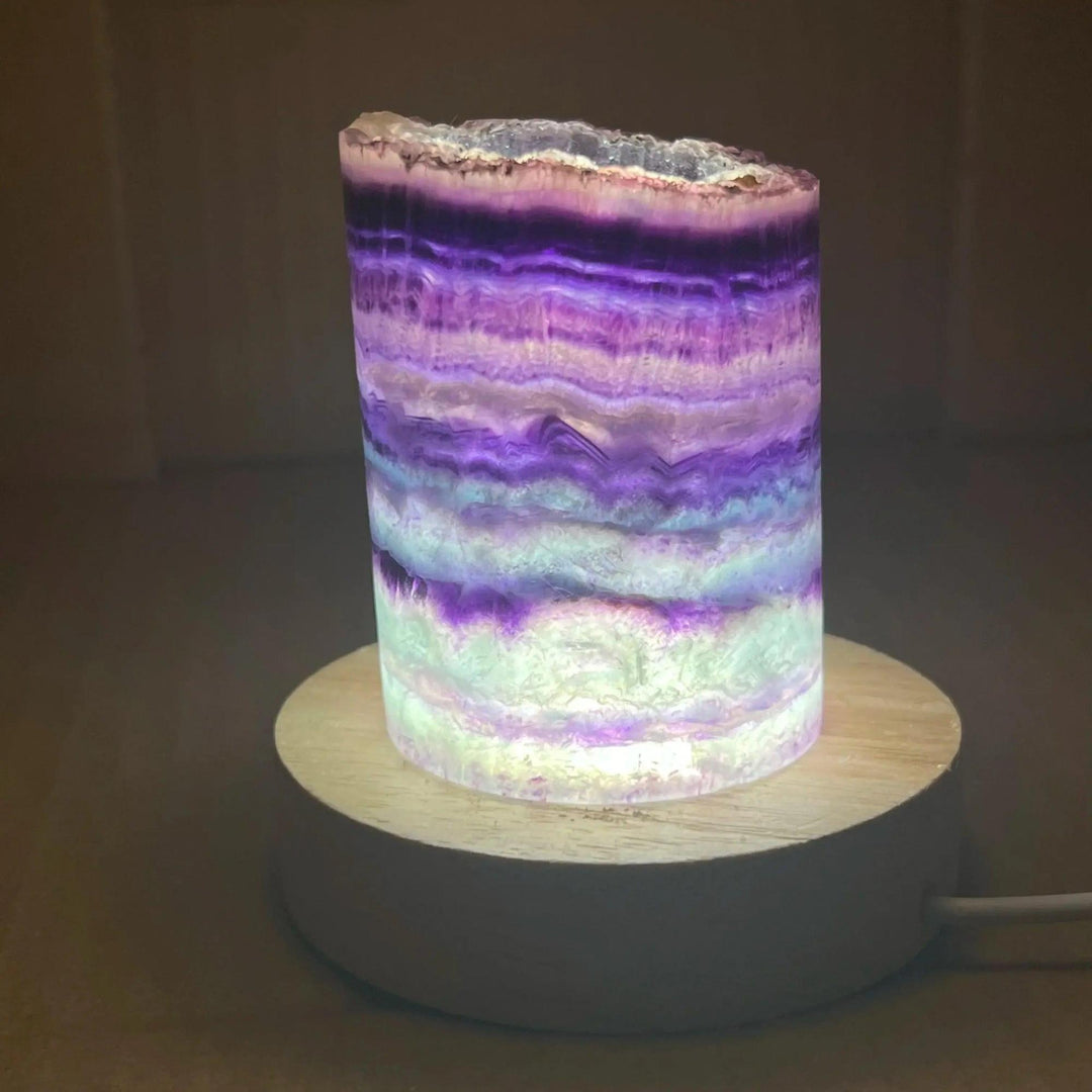 Stunning Rainbow Fluorite Crystal Light Lamp with mesmerizing purple, green, blue bands for clarity and balance.
