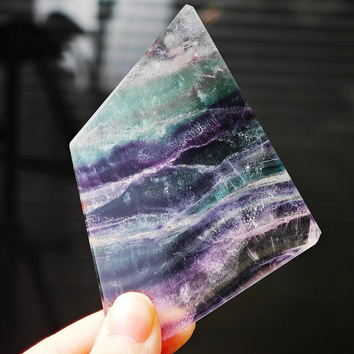 Natural Rainbow Fluorite slice with vibrant purple and green bands, perfect for Reiki healing and spiritual decor.