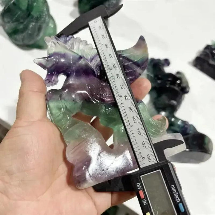 Rainbow Fluorite Unicorn Carving by Crystal Destiny, showing purple, green, and clear tones, measured by calipers.