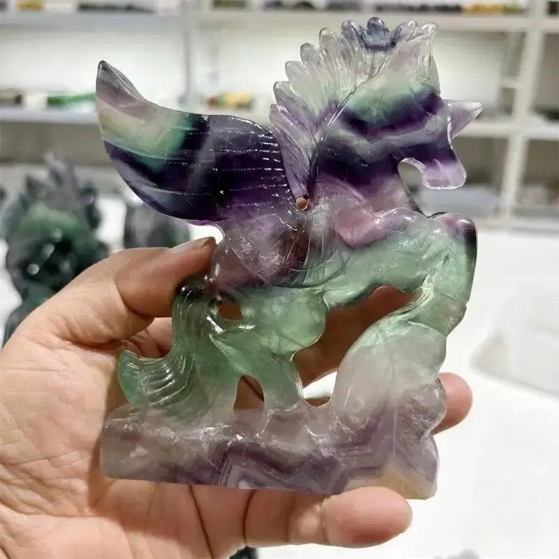 Rainbow Fluorite Unicorn Carving from Crystal Destiny, showcasing purple, green, and clear bands for clarity and magic.