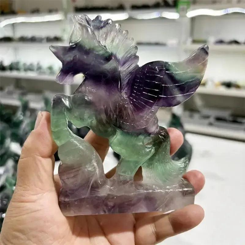 Rainbow Fluorite Unicorn Carving by Crystal Destiny, featuring purple, green, and blue hues.