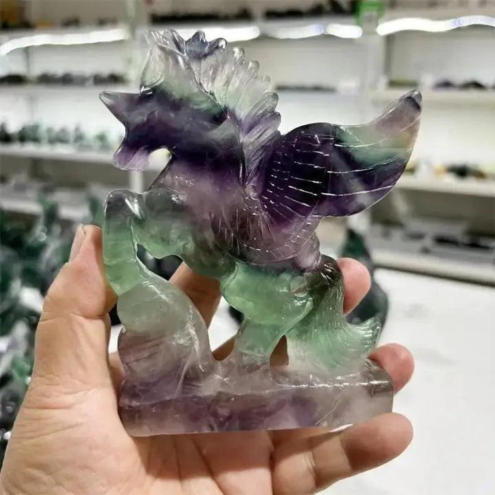 Rainbow Fluorite Unicorn Carving by Crystal Destiny, featuring purple, green, and blue hues.