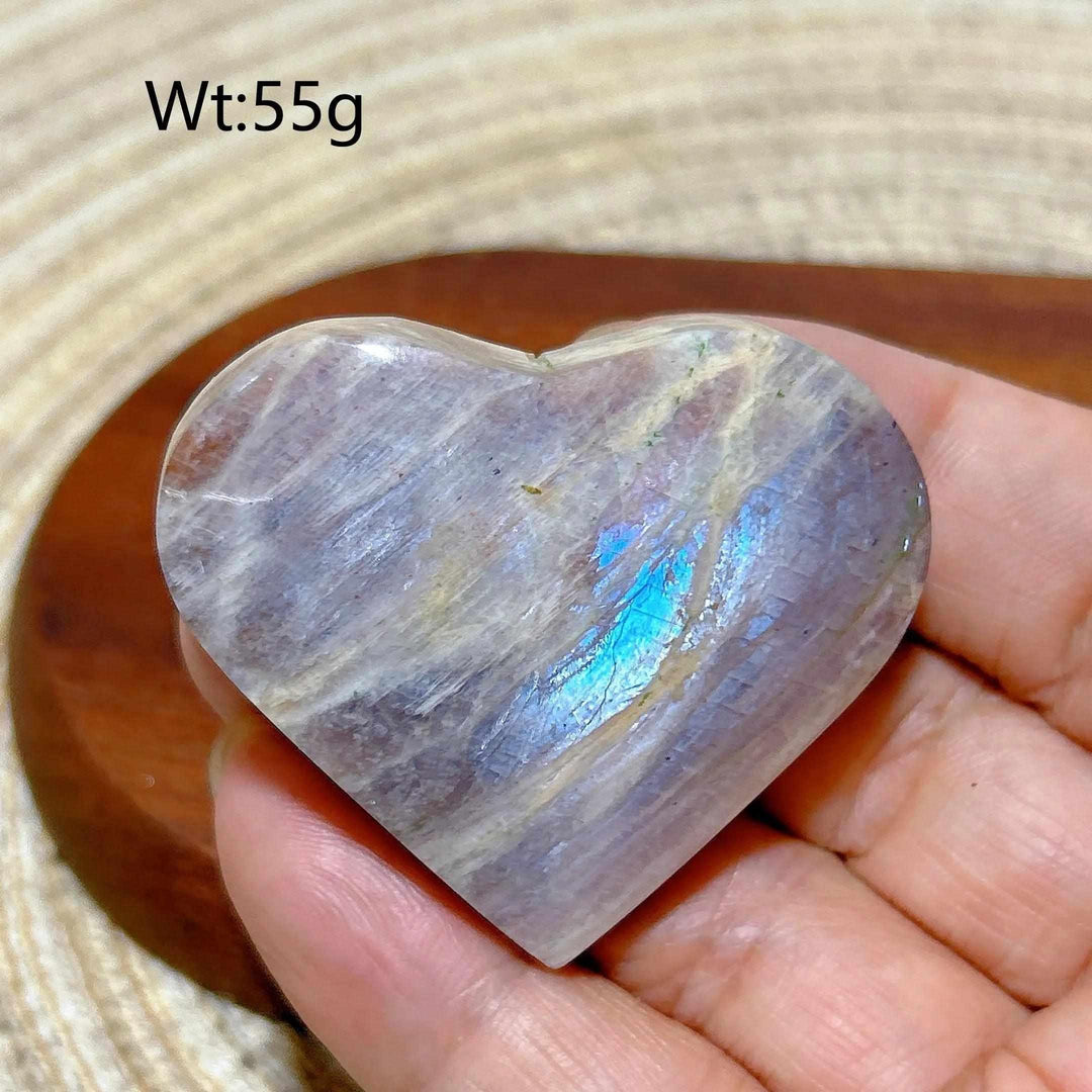 Polished 55g Rainbow Moonstone and Sunstone heart featuring milky white and orange tones with a vibrant blue flash.