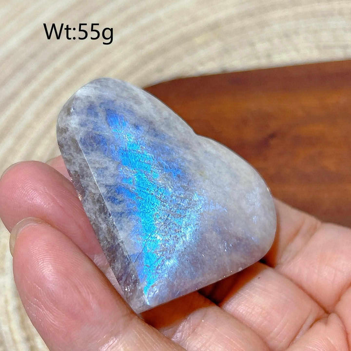 Polished Rainbow Moonstone and Sunstone heart featuring a vibrant blue flash, 55g, for sacral and solar plexus chakra balance.